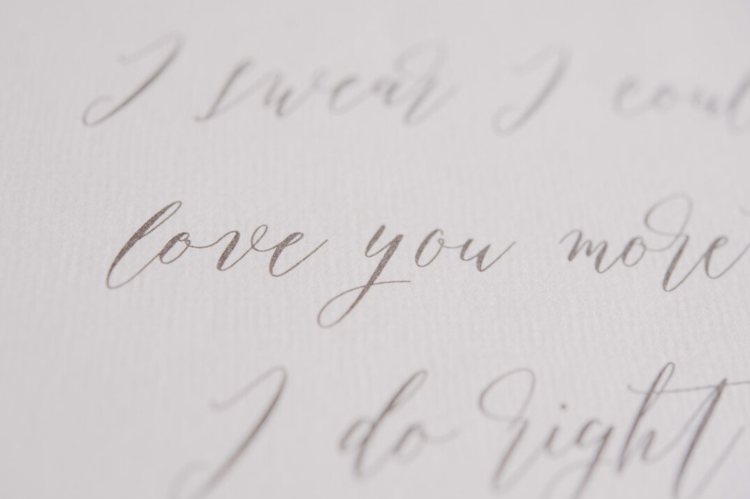 Open notebook with handwritten notes and a pen on a wooden desk